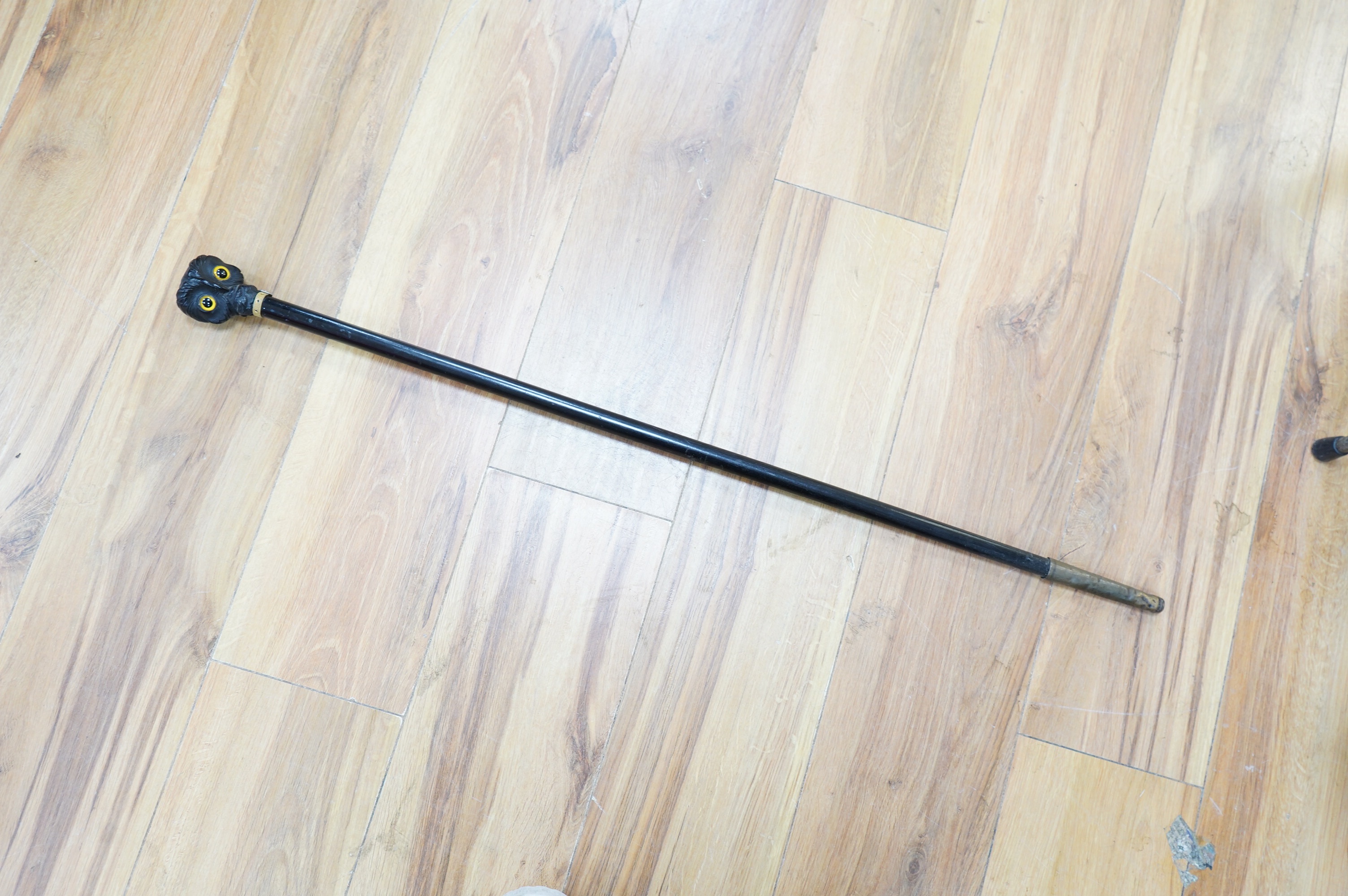 A Victorian ebony 'owl's head' walking stick, 85cm long. Condition - good.